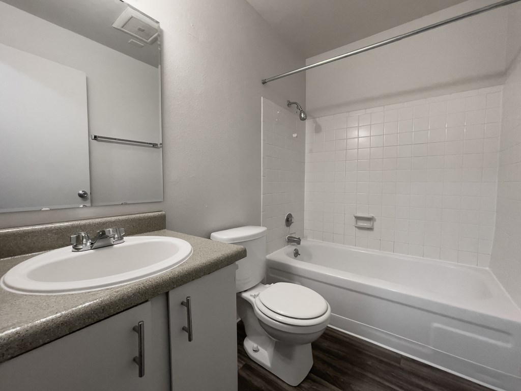 an empty bathroom with a sink toilet and bath tub