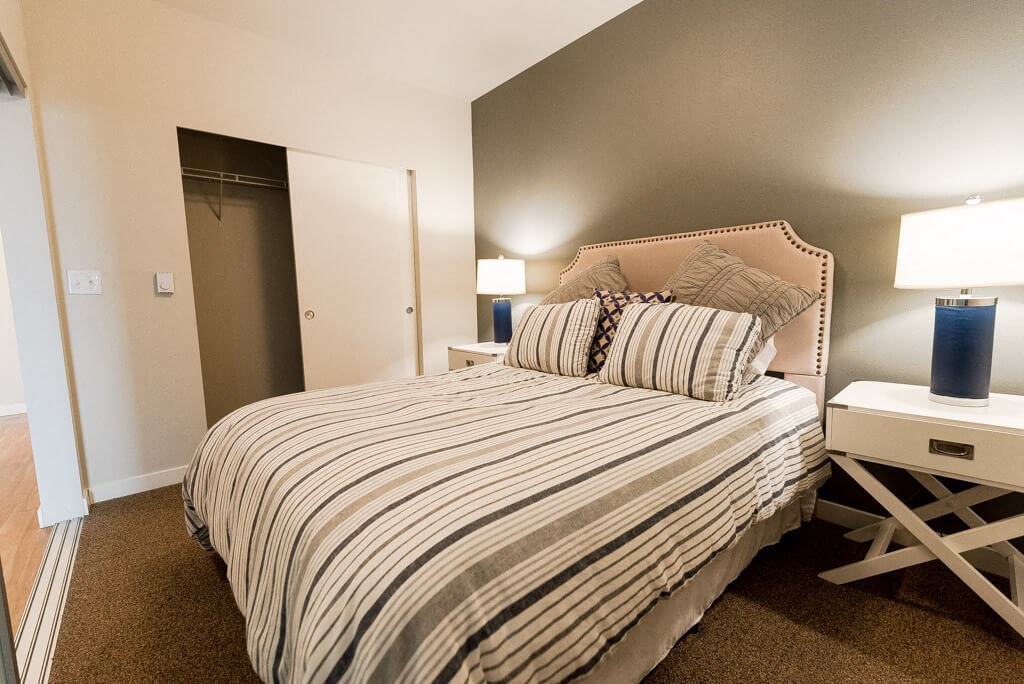 A bedroom with a bed, nightstand, and lamp. A bedroom with a bed, nightstand, and lamp. at The Platform, Washington, 98032