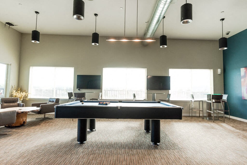 A room with a pool table and a television. A room with a pool table and a television. at The Platform, Washington