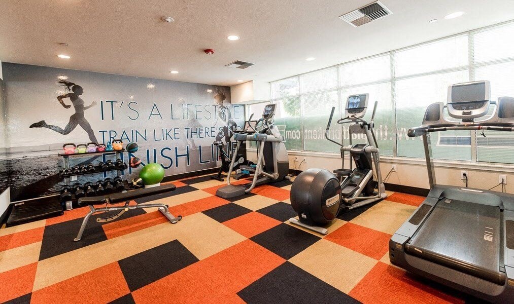 A gym with a running track and a wall mural that says A gym with a running track and a wall mural that says at The Platform, Kent
