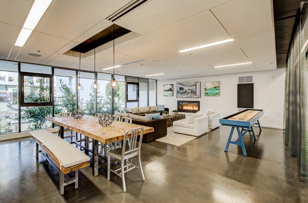 A modern dining room with a wooden table and chairs.