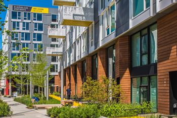 A modern apartment complex with a mix of brick and glass buildings.