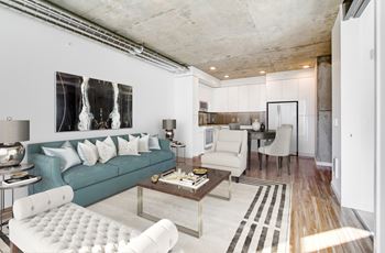 A modern living room with a blue couch and a coffee table.