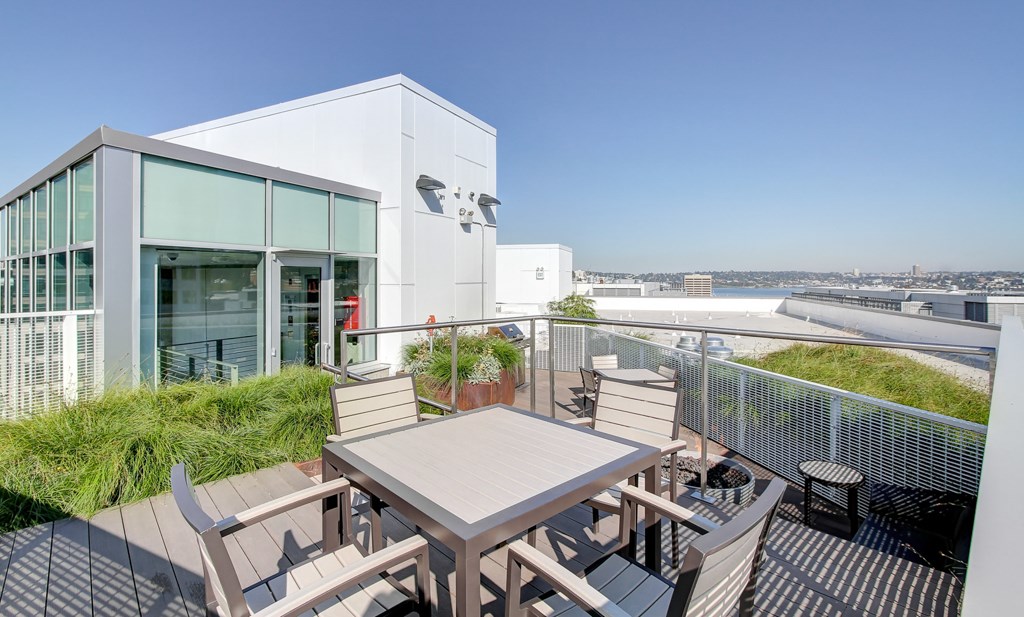 A modern building with a patio and a table.
