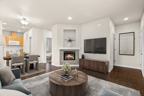 A modern living room with a fireplace and a flat screen TV.