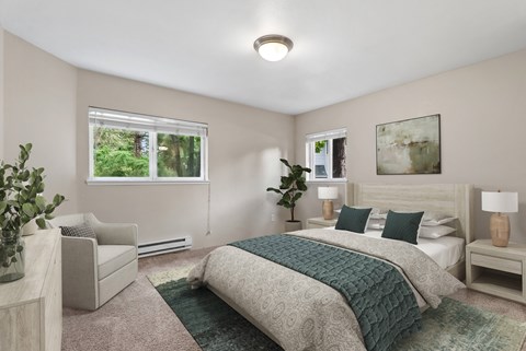 A bedroom with a large bed and a chair.