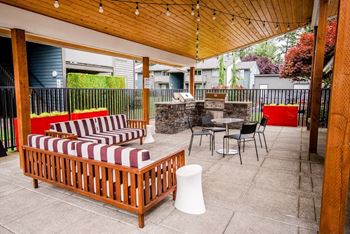 a covered patio with furniture and a table and chairs at Aero Apartments, Washington, 98444