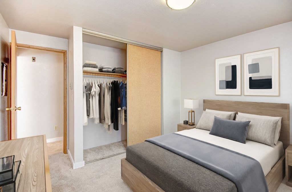 A bedroom with a large bed and a wardrobe.