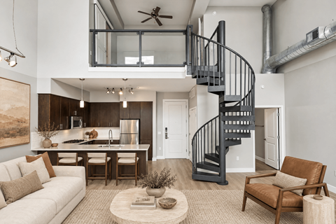 A modern living room with a spiral staircase leading to the upper floor.
