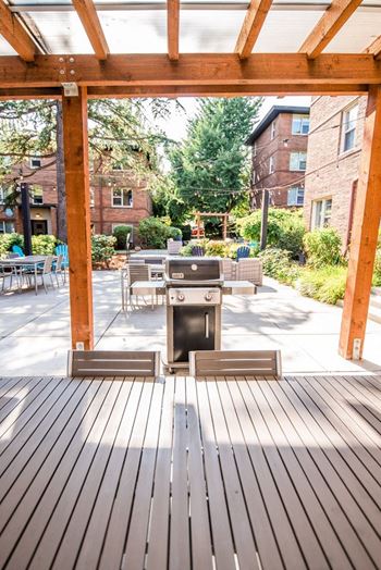 a patio with a grill and a table and chairs at Cadence, Washington