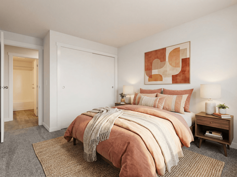 A bedroom with a large bed and a painting on the wall.