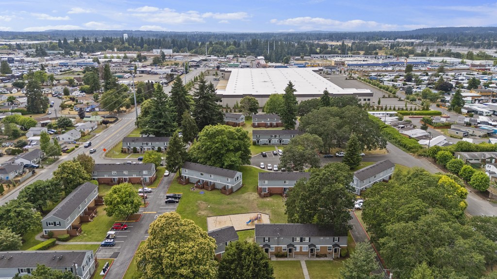 A large aerial view of a town with a mix of residential and commercial buildings.