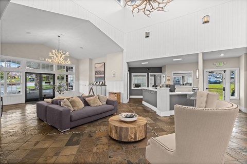 A living room with a grey couch and a wooden coffee table.