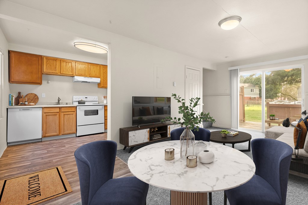 A modern kitchen with a dining table set for two.