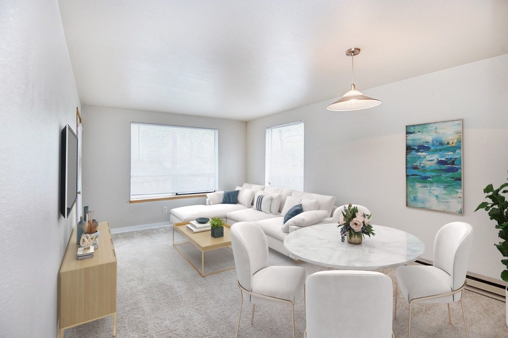 A living room with a white couch and a coffee table.