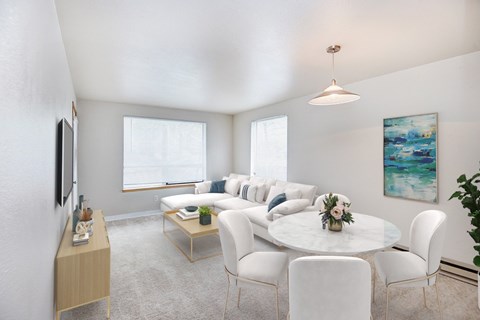 A living room with a white couch and a coffee table.