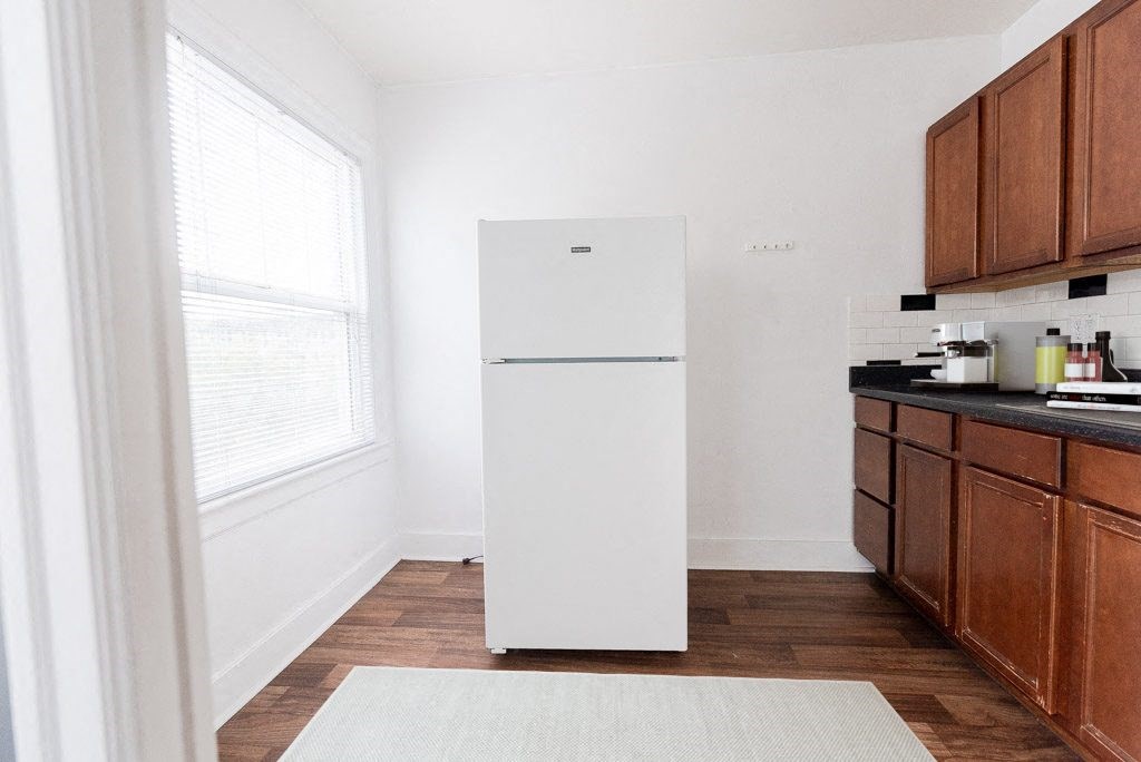 a kitchen with a white refrigerator and wooden cabinets at Edwards on Fifth, Washington, 98121