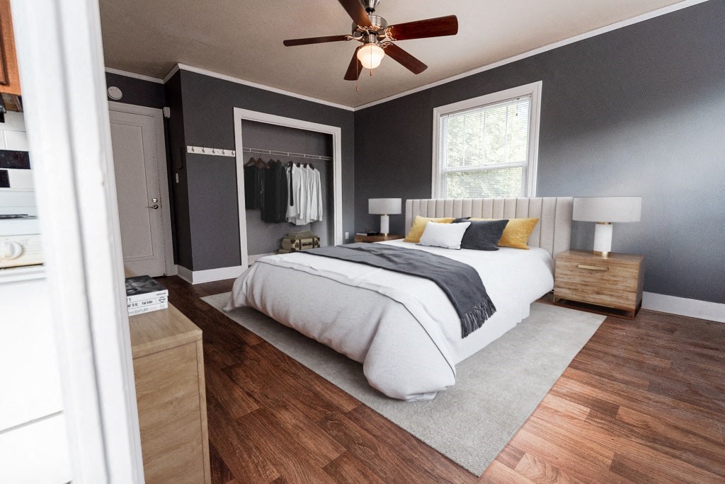 a bedroom with a bed and a ceiling fan at Edwards on Fifth, Seattle, WA