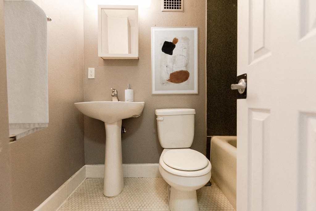 a small bathroom with a toilet and a sink at Edwards on Fifth, Seattle