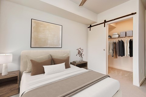 A bedroom with a large bed and a painting on the wall.