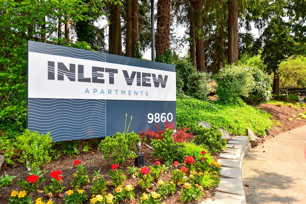 a sign at the entrance to the inlet view apartments