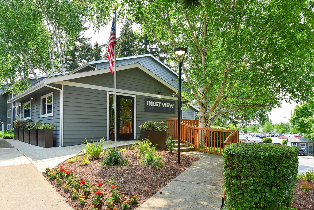 a gray building with an american flag in front of it
