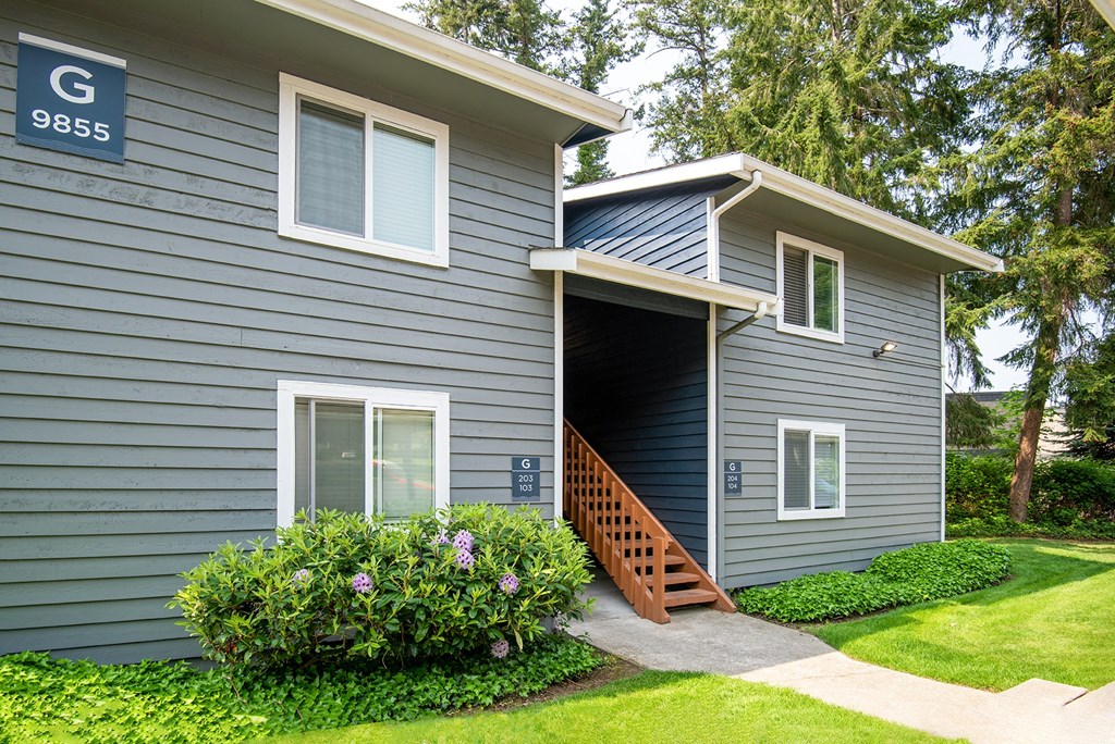 a blue house with an open garage door
