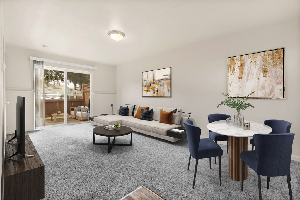A living room with a grey carpet and a white table.