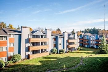 A row of modern apartment buildings with green lawns in front. at Northpoint Apartments, Tacoma, WA, 98407