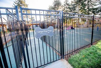 A black metal gate with a sign that says Large Dog Area. at Northpoint Apartments, Washington, 98407