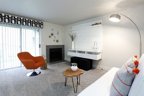 a living room with a couch and a table and a fireplace