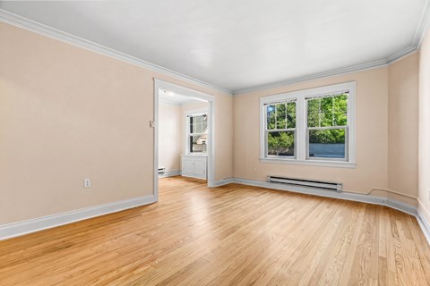 A room with a window and a radiator on the wall.