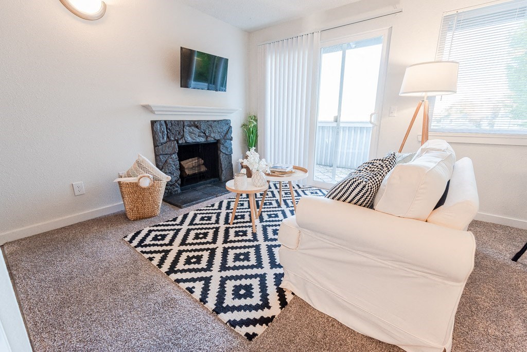 living room with couch and tv at ReVive Apartments, Fife