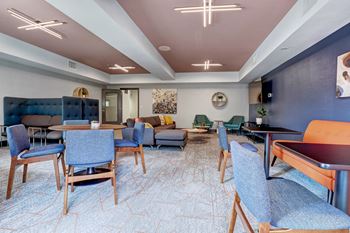 a lounge area with tables and chairs and a pool table