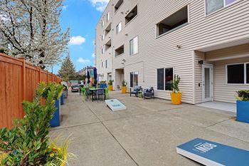 a patio with tables and chairs outside of a building