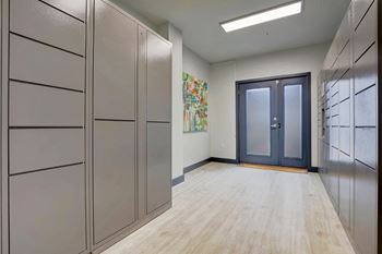a long hallway with cabinets and a door to a closet