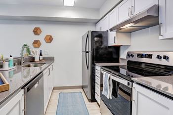 a kitchen with stainless steel appliances and granite counter tops