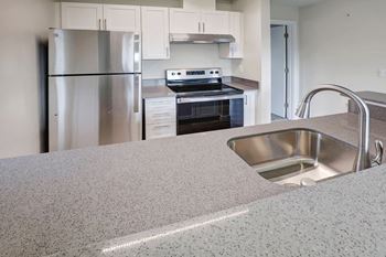 a kitchen with stainless steel appliances and a sink