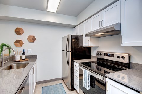 a kitchen with stainless steel appliances and white cabinets
