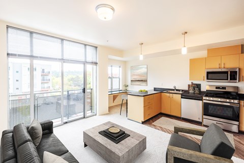 A modern living room with a grey sofa and a coffee table in the center.