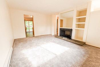 A room with a fireplace and a window. at The Retreat, Washington, 98390