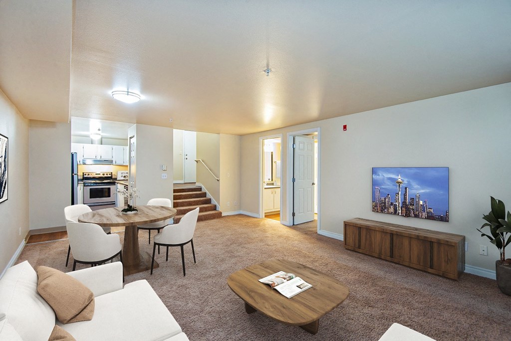 a living room with a couch and a table and a tv at Ellis Court Apartments, Seattle, Washington