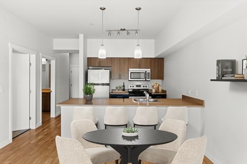 A modern kitchen with a dining table and chairs.