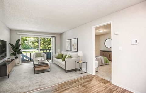 A living room with a white couch and a coffee table.