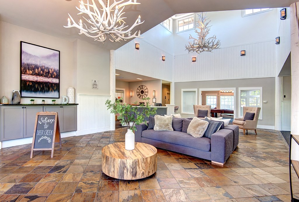 Clubhouse interior with couchat Deer Creek Apartments, Puyallup, WA, 98373