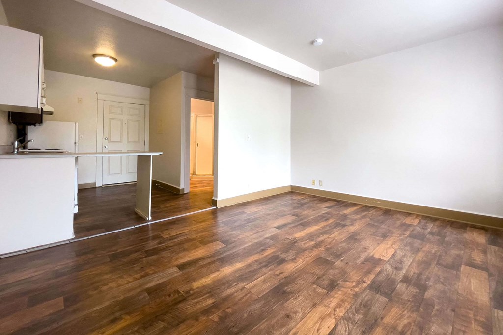 A room with wooden floors and white walls. at Zindorf, Seattle, WA, 98104