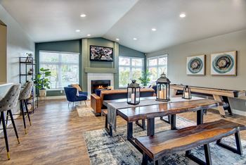 a living room with a dining room table and a fireplace
