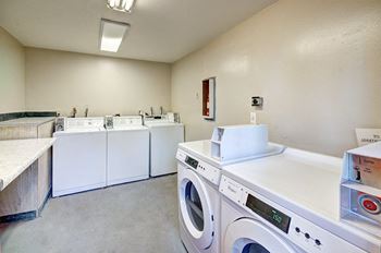 a washer and dryer room with washing machines and other appliances