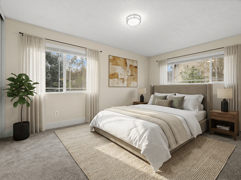 A bedroom with a large bed and a plant.