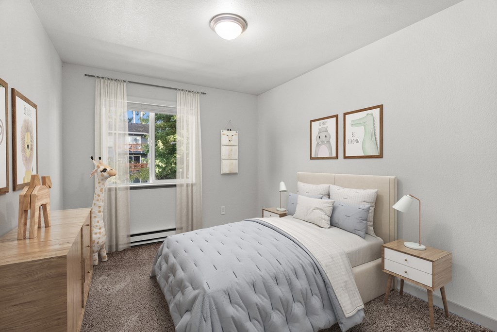 A bedroom with a bed, nightstand, and a window with a view of the outside.